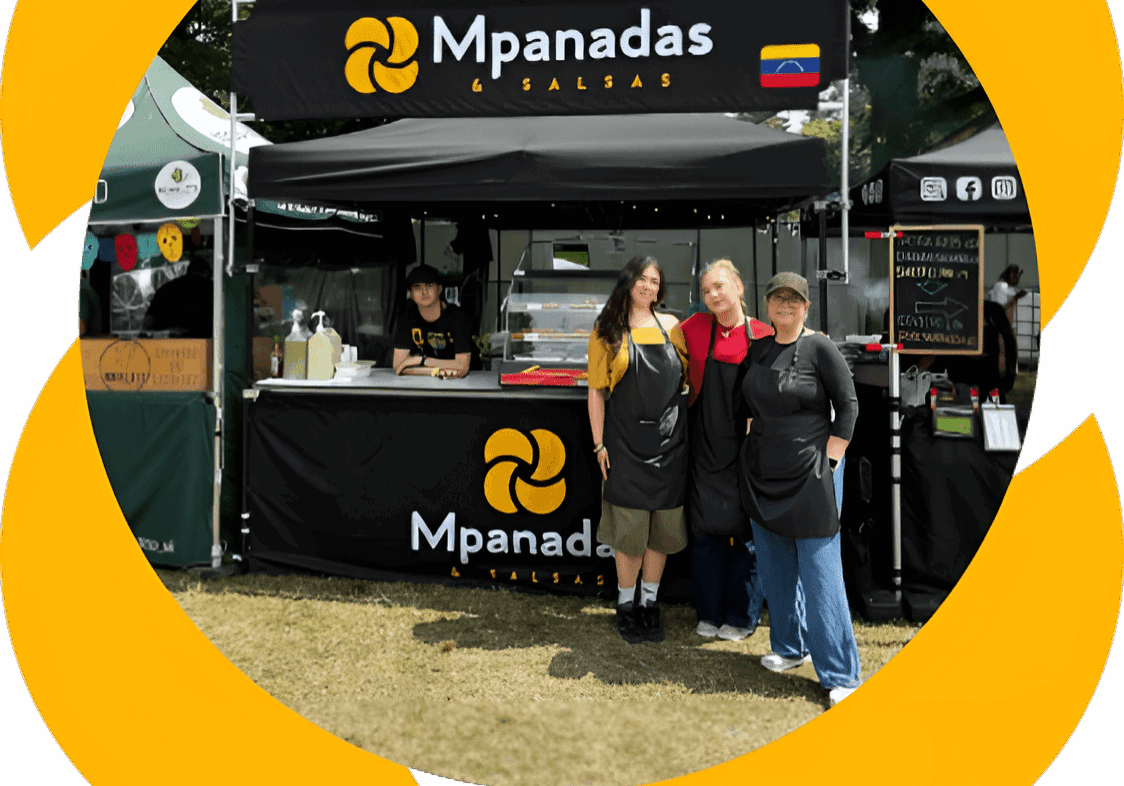People standing in front of a food stall named Mpanadas.