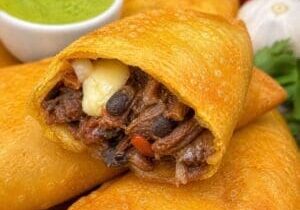 Savoury beef and black bean empanadas with melted cheese and plantain - Illustrative Image